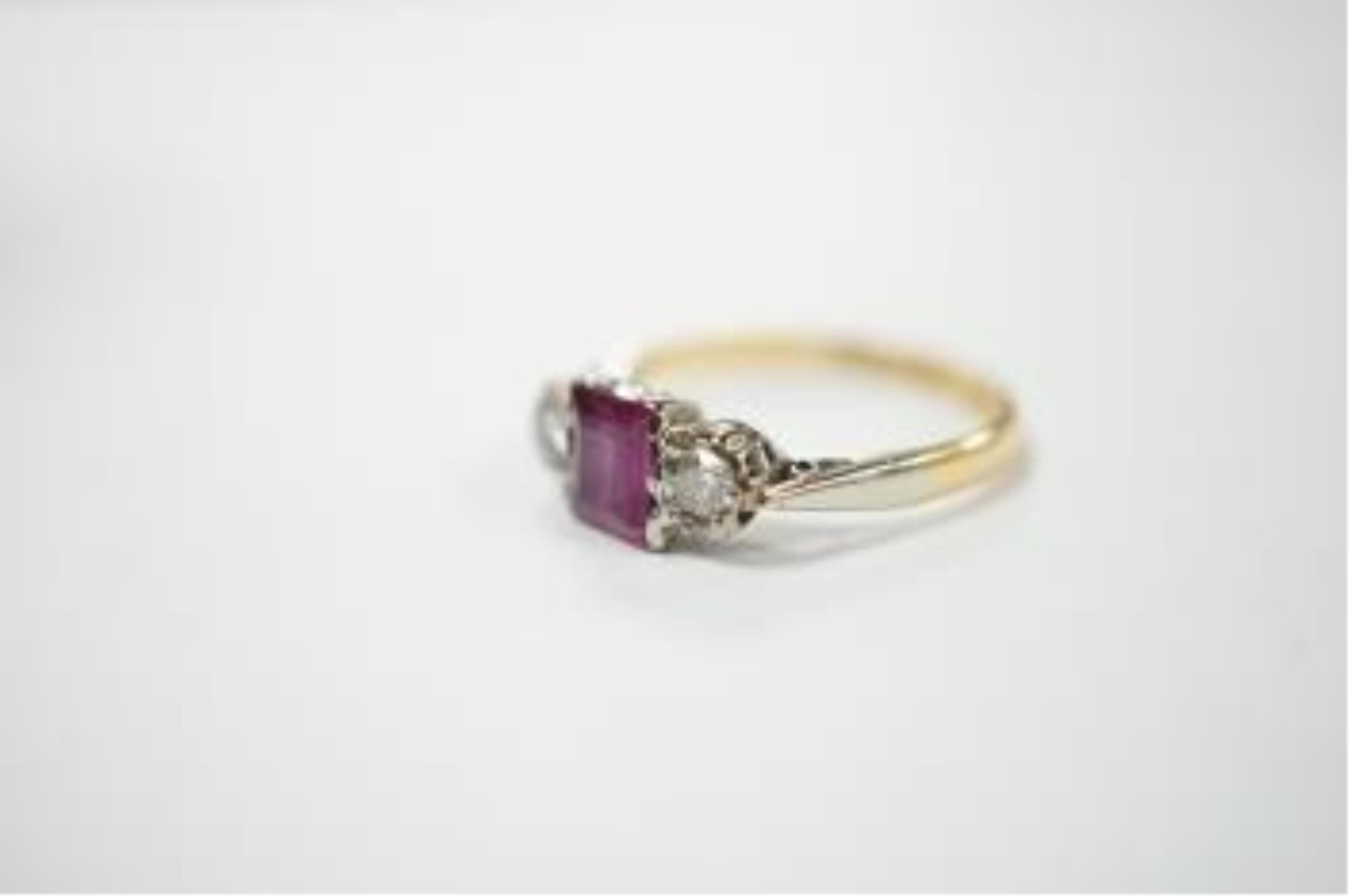 An 18ct & plat. ruby and diamond set three stone ring, size K, gross weight 2.3 grams. Condition - fair